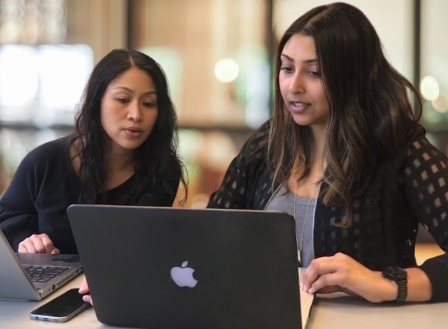 Two women looking at laptop screen