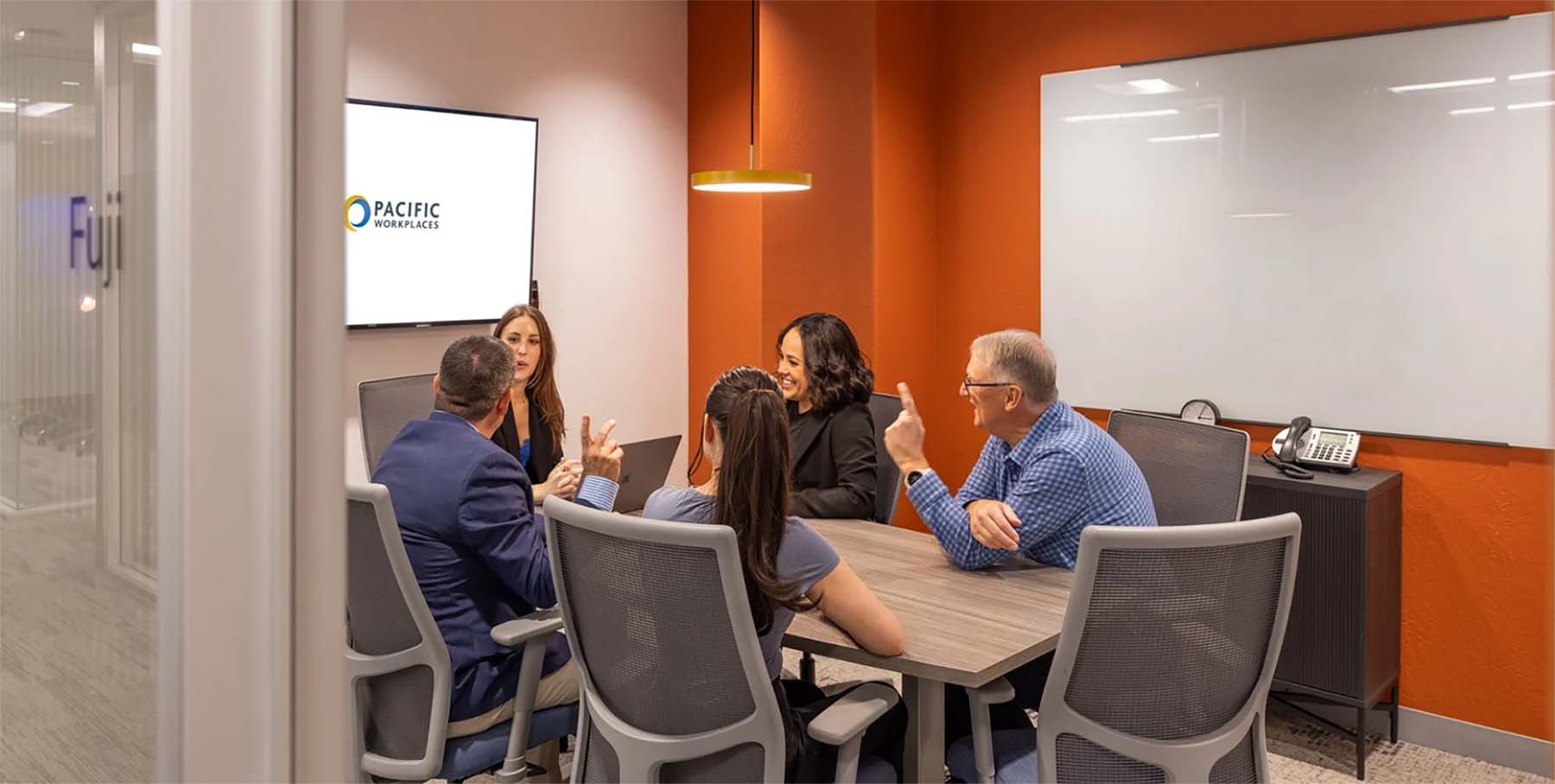 Team collaborating in meeting room at pacific workplaces in cupertino ca