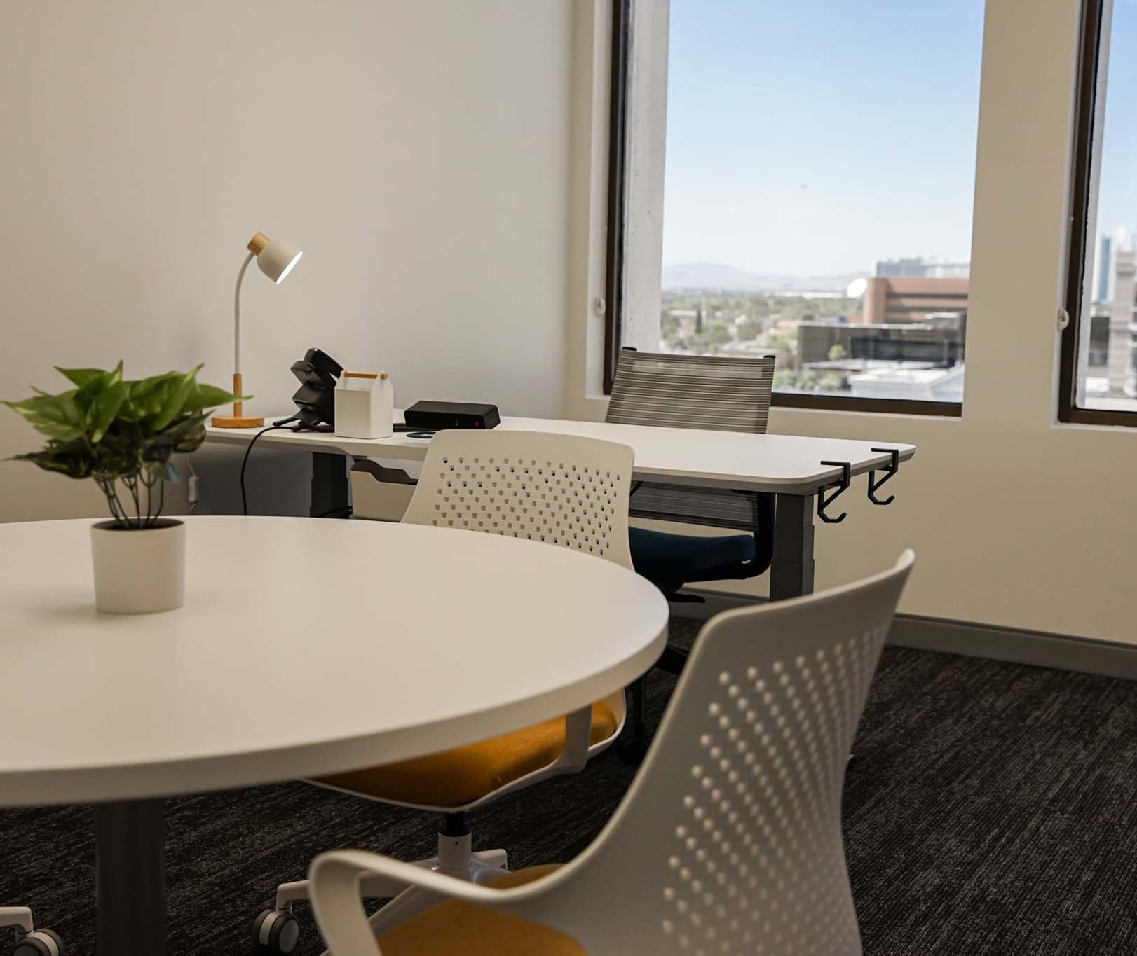 Private office space for rent in Las Vegas with desk, table and chairs