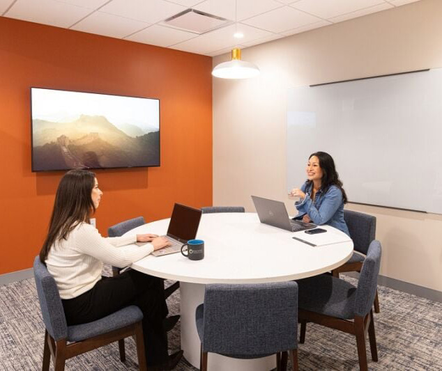 Two women sitting at a table in an office space rental in San Francisco Two women sitting at a table in an office space rental in San Francisco