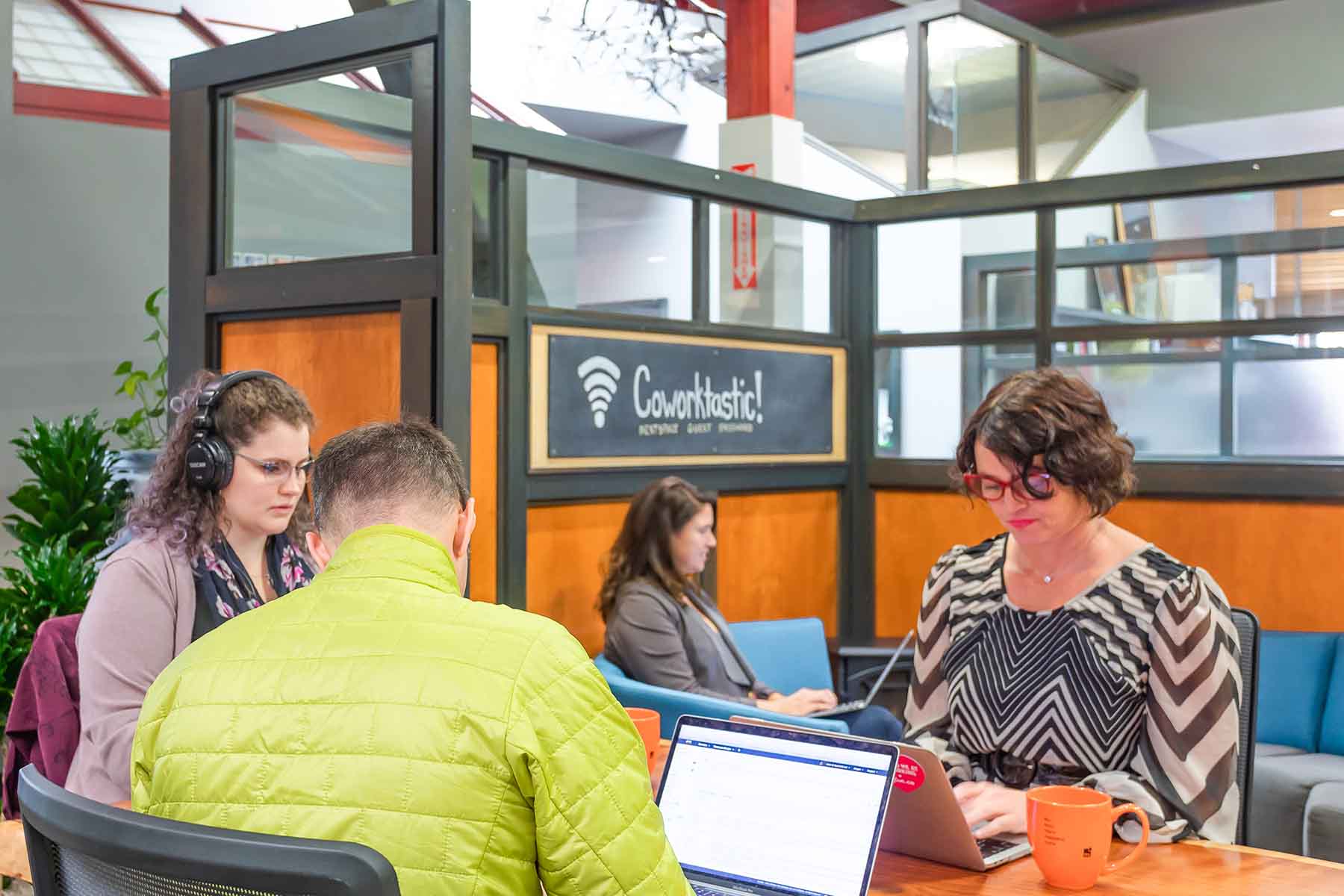 Three people at desk waiting for private office space in Santa Cruz