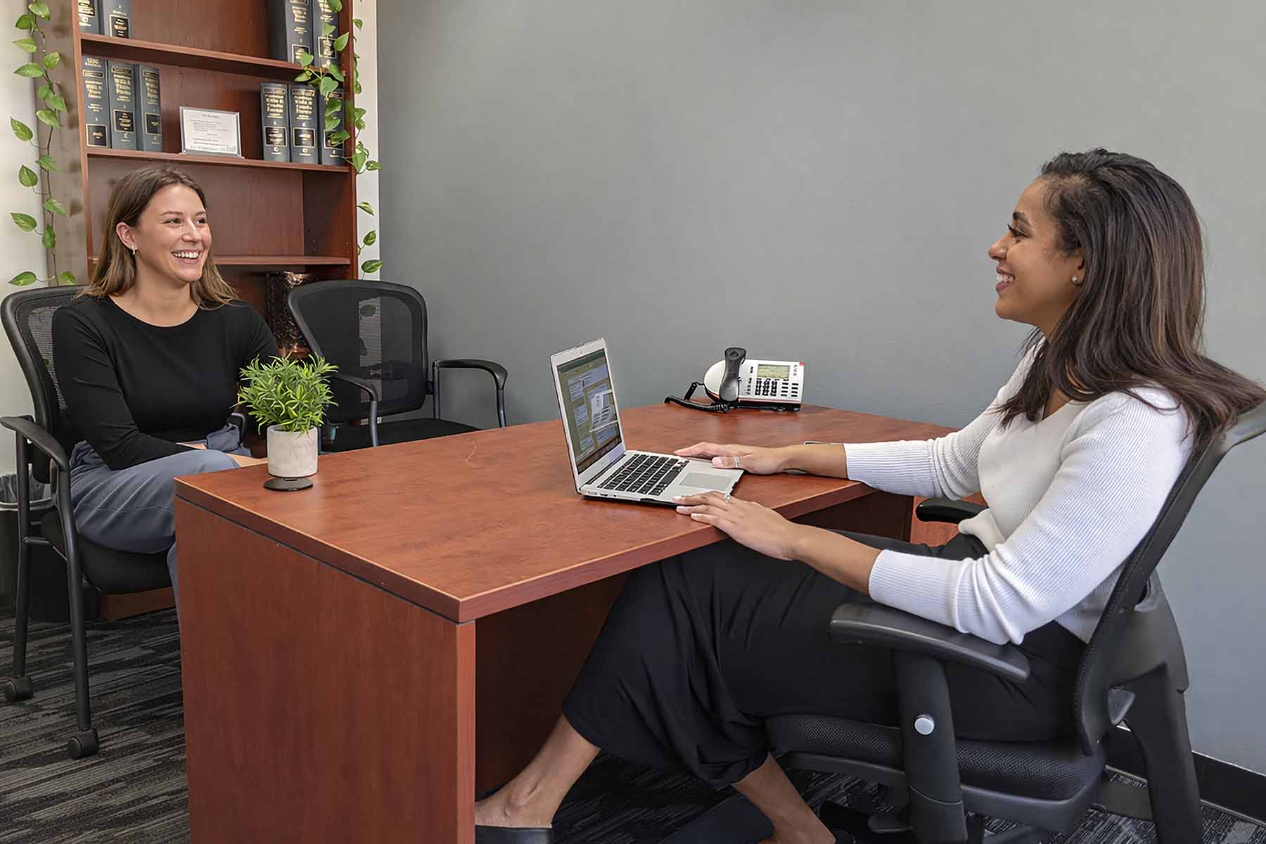 Oakland Office Space - rs Two women laughing in a private office in Oakland