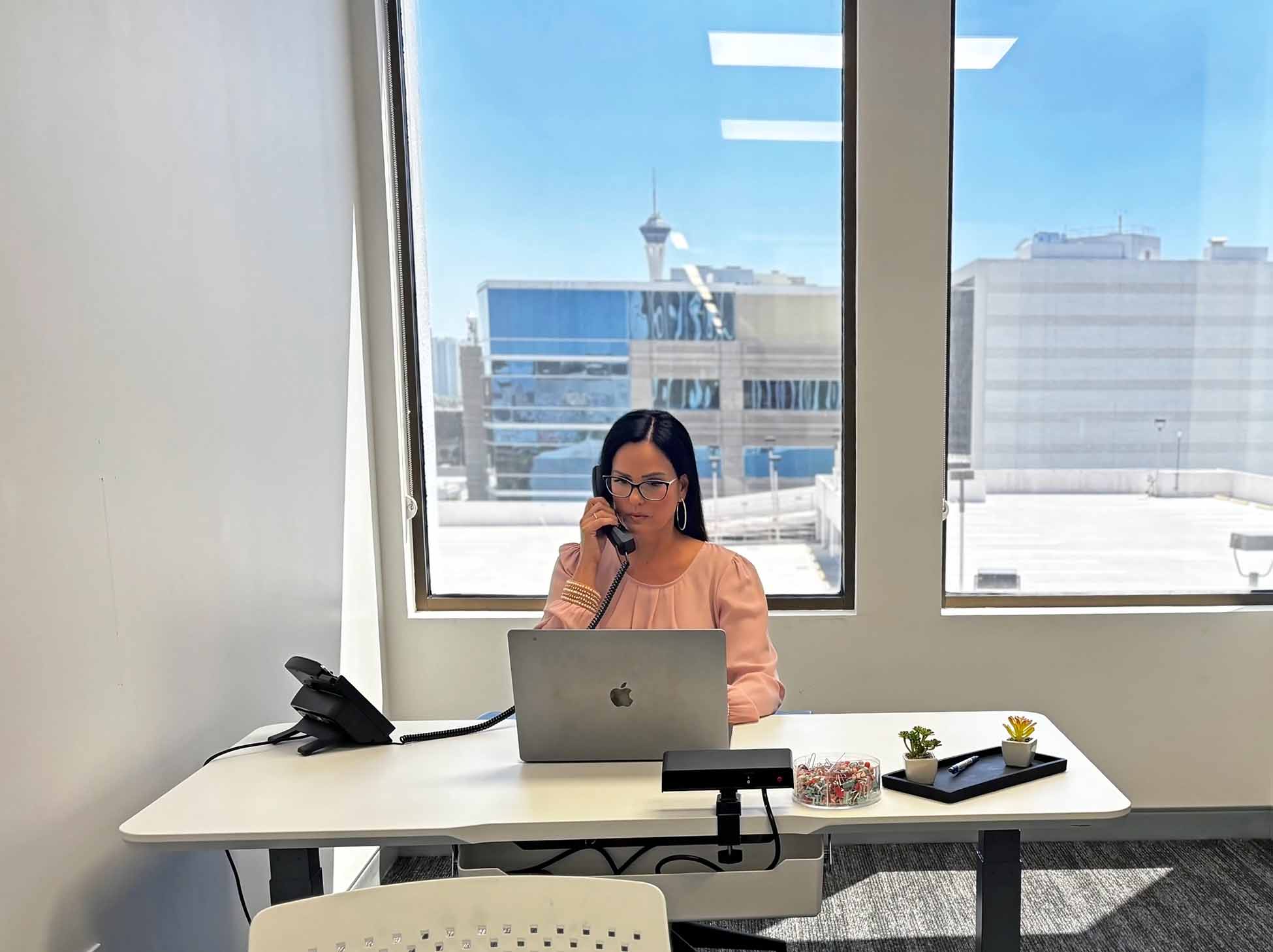 Woman on phone at desk in private office space in las vegas