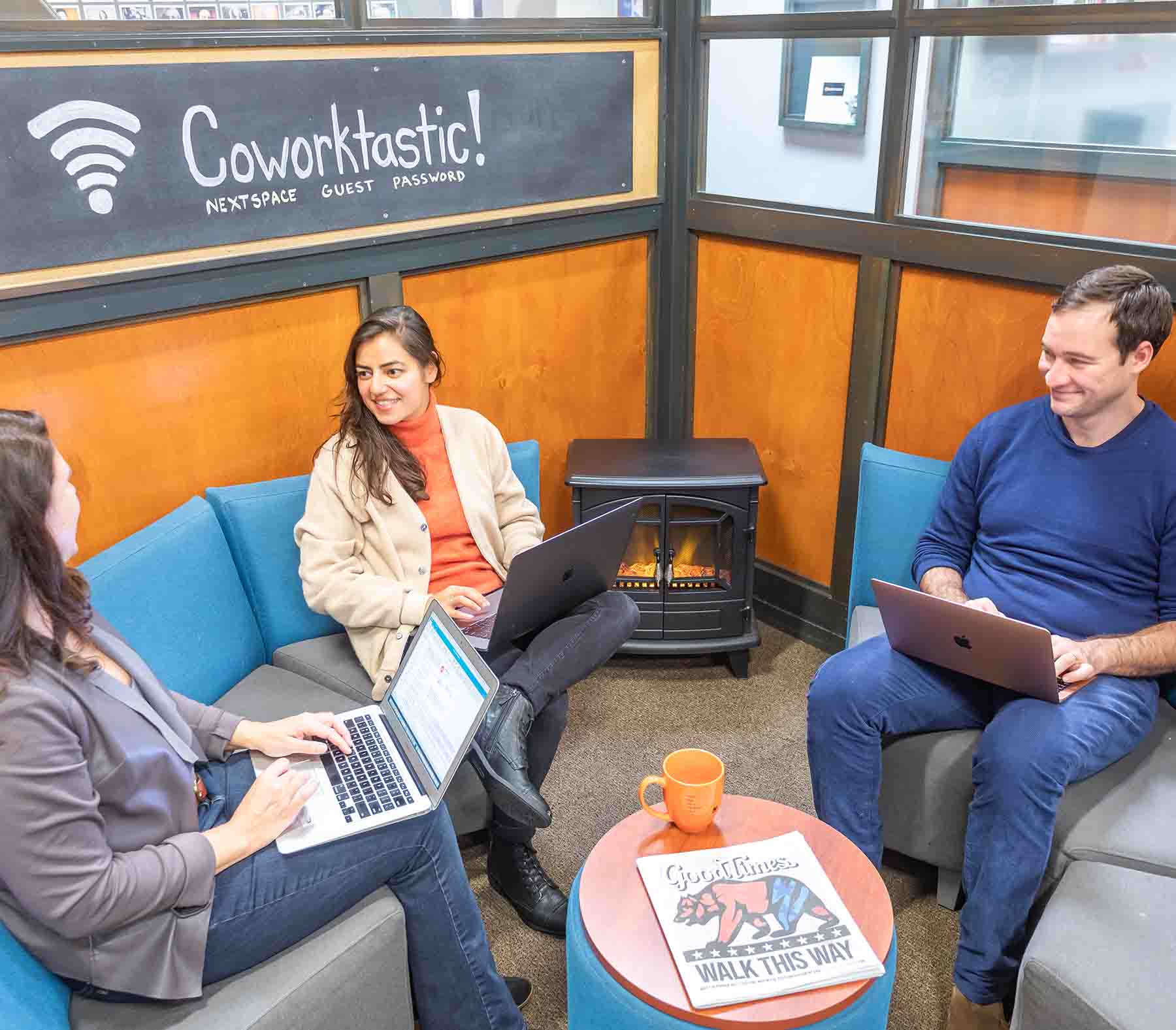 Three people sitting in chairs with laptop at NextSpace Santa Cruz