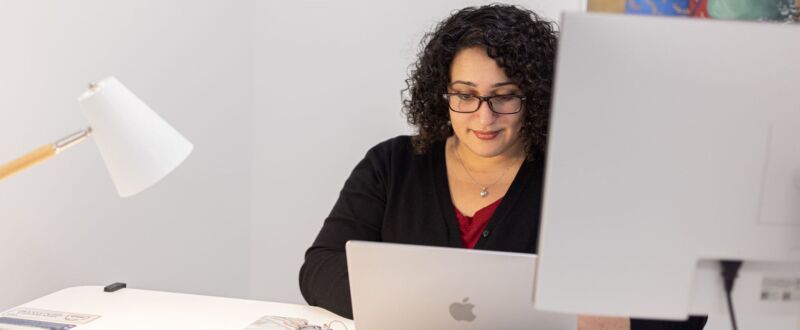 Woman at desk with laptop in private office space in Oakland