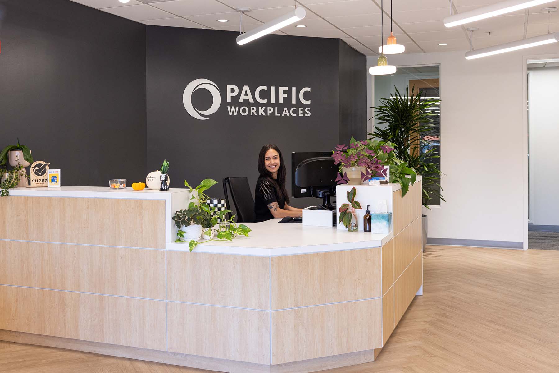 Person smiling at reception desk at coworking space in Pleasant Hill
