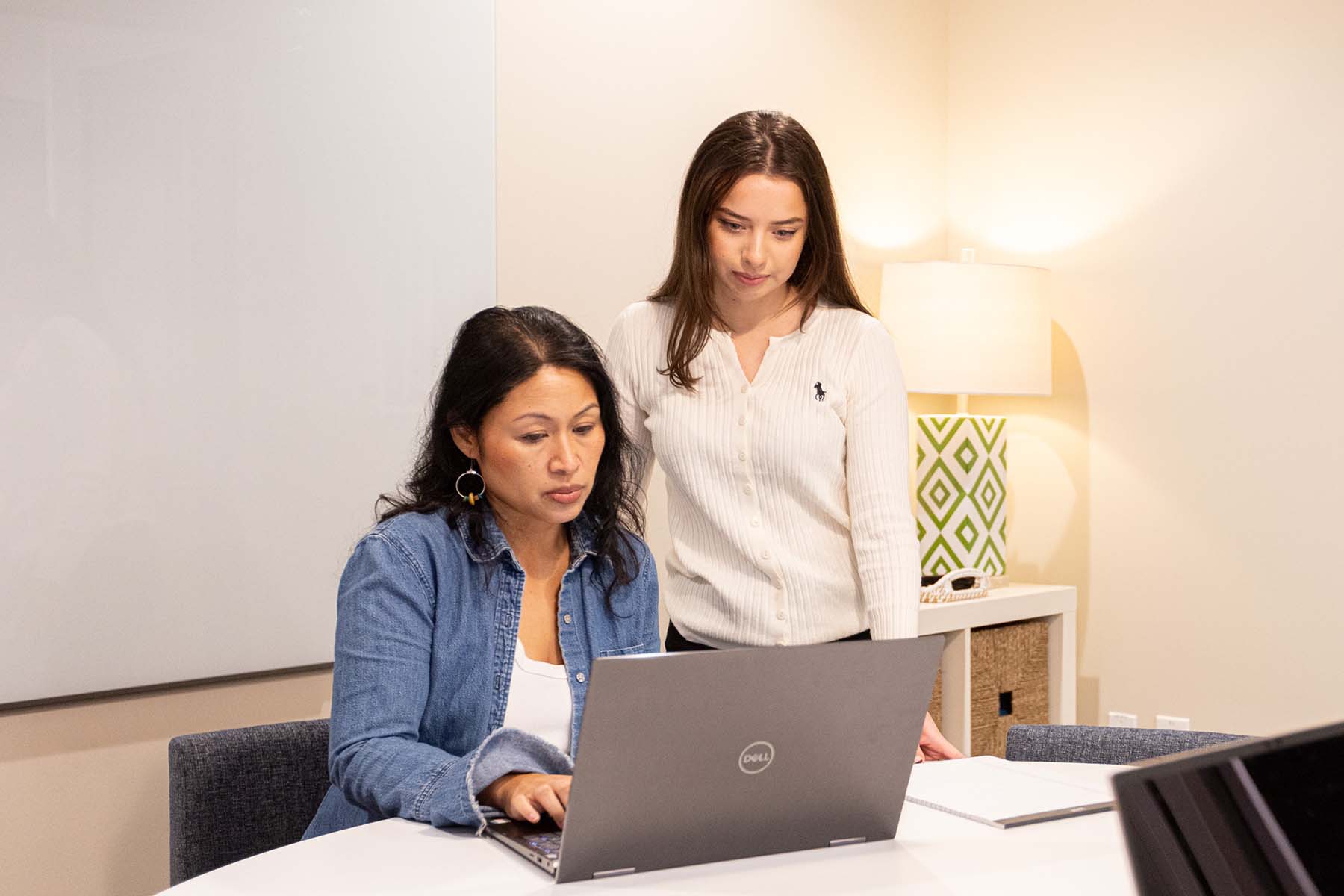 Two women reviewing a laptop screen in a private office in Walnut Creek