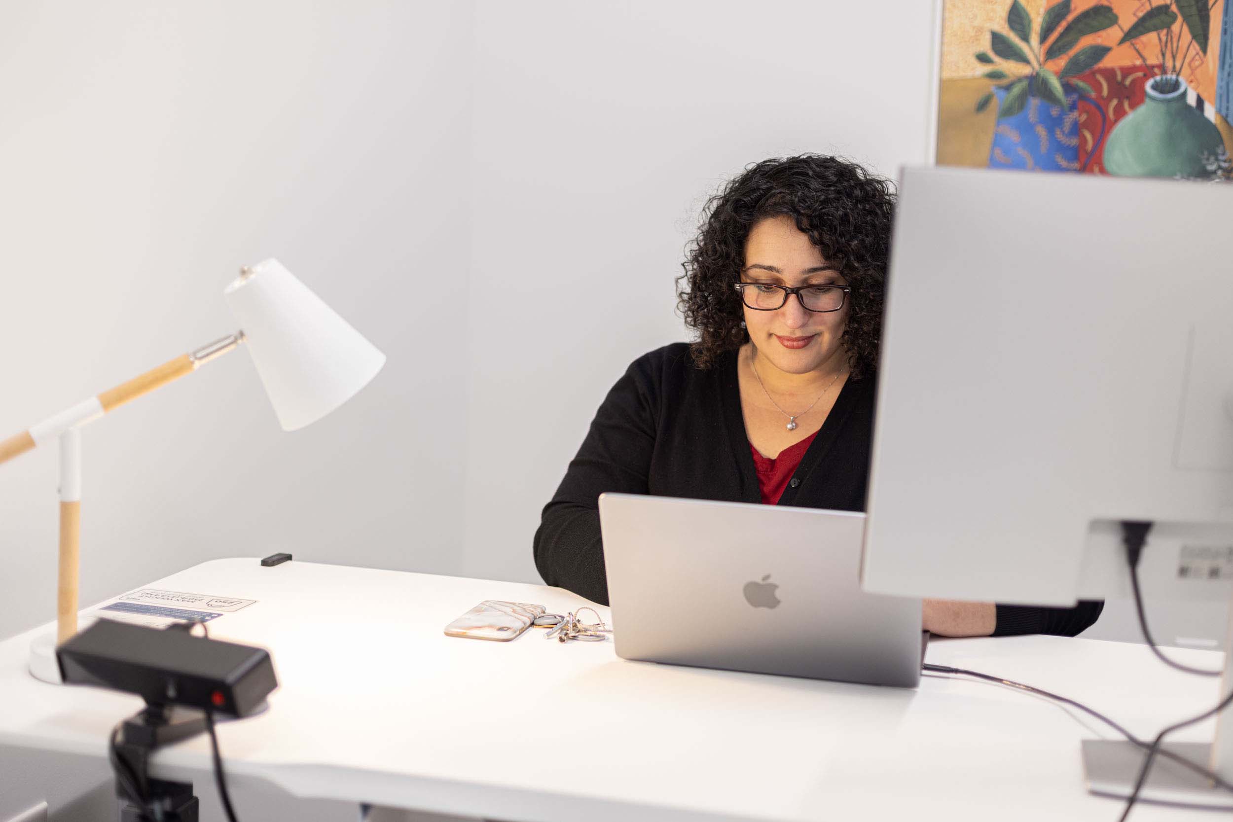 Woman at desk with laptop in private office space in Watt Sacramento