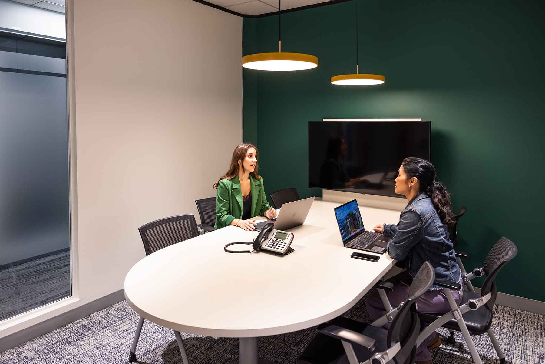 two women working on laptops in a meeting room in pleasant hill ca