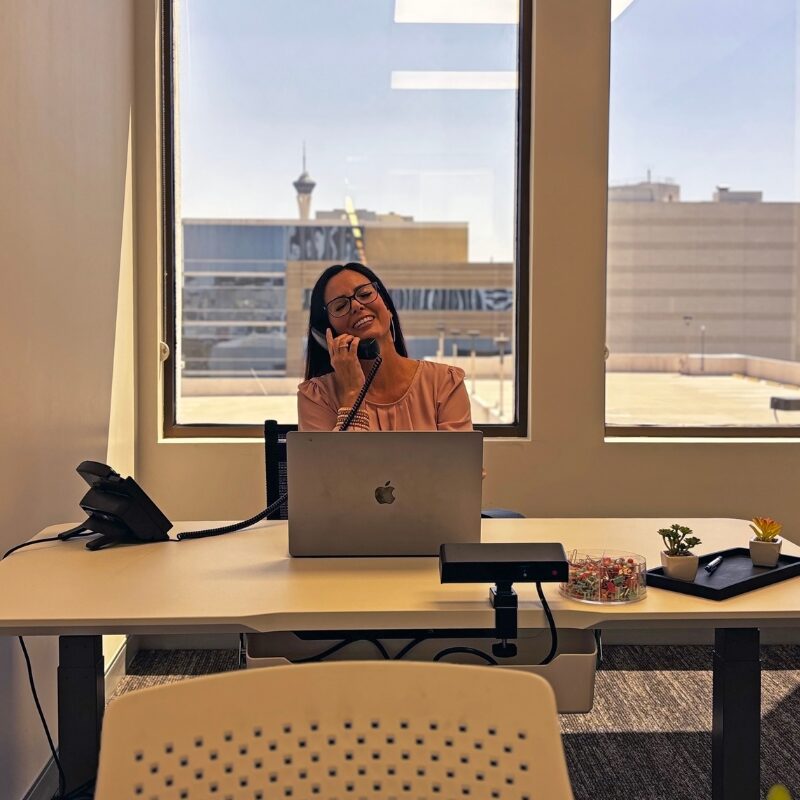 Woman answering the phone and working on a laptop in a private office in walnut creek ca