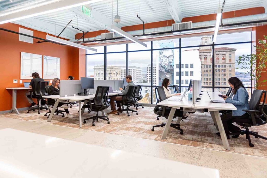 men and women working on laptops in a coworking space in San Jose CA