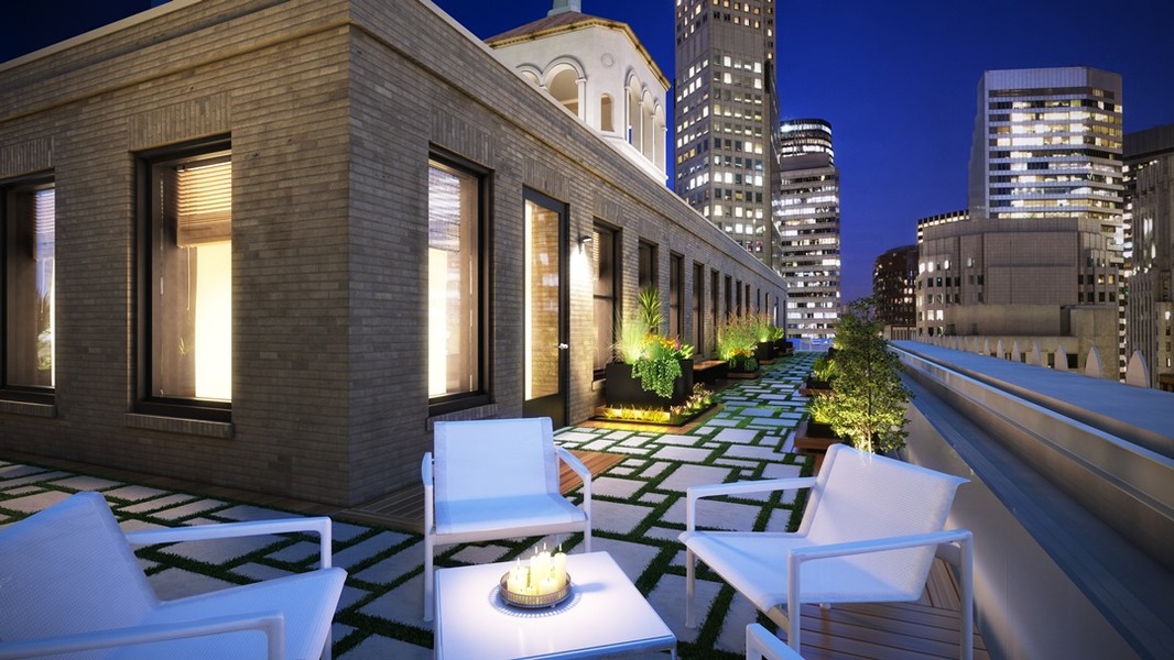 Rooftop of Pacific Workplaces Montgomery location with SF skyline at night.